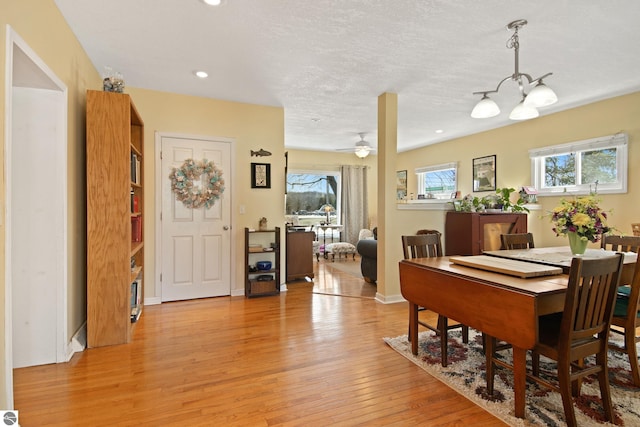 112 N Benzie Blvd, Beulah, MI 49617 - dining space with light wood-type flooring, healthy amount of natural light, a chandelier, recessed lighting, and ceiling fan