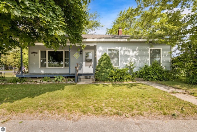 112 N Benzie Blvd, Beulah, MI 49617 - view of front of property featuring a front yard and a chimney
