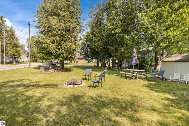 112 N Benzie Blvd, Beulah, MI 49617 - view of green lawn featuring a fire pit