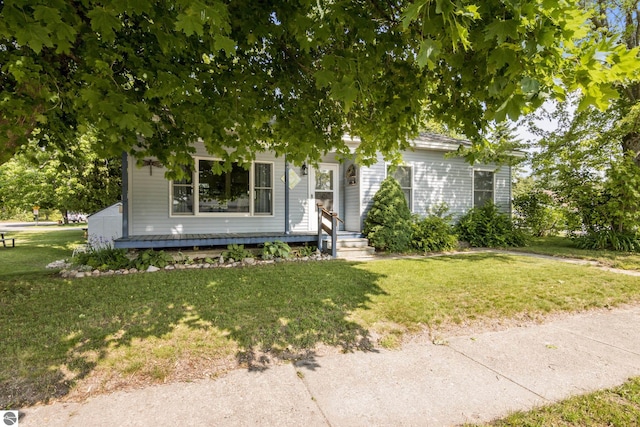 112 N Benzie Blvd, Beulah, MI 49617 - view of property hidden behind natural elements with a front yard