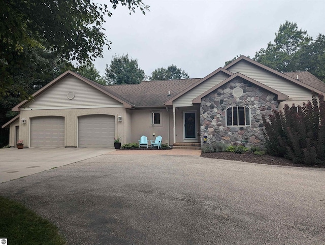 8544 Esmond Rd, Hale, MI 48739 - ranch-style house featuring driveway, an attached garage, and stone siding