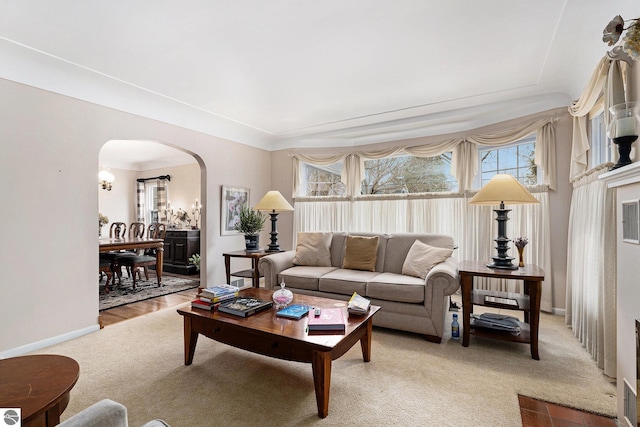 739 Stimson St, Cadillac, MI 49601 - living room with arched walkways, light colored carpet, and baseboards