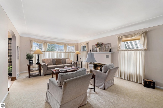 739 Stimson St, Cadillac, MI 49601 - living room with light colored carpet, arched walkways, and baseboards