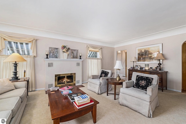 739 Stimson St, Cadillac, MI 49601 - carpeted living room with a glass covered fireplace, arched walkways, and baseboards