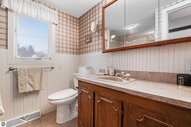 739 Stimson St, Cadillac, MI 49601 - bathroom featuring wallpapered walls, vanity, tile patterned floors, toilet, and a wainscoted wall