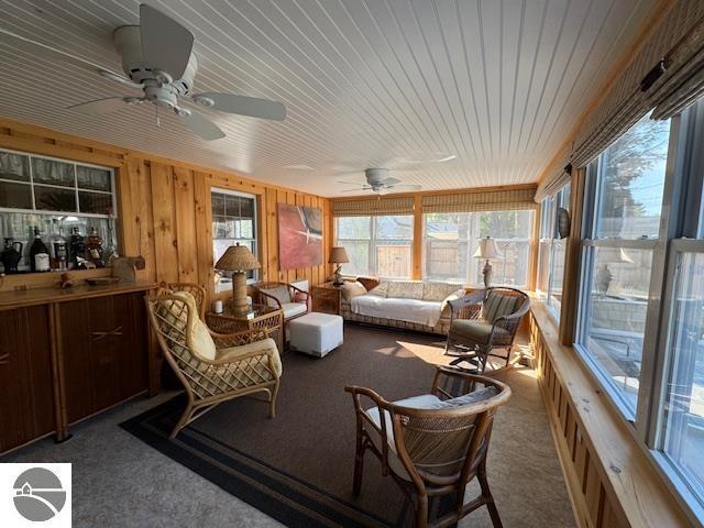 739 Stimson St, Cadillac, MI 49601 - sunroom / solarium featuring carpet flooring and wooden walls