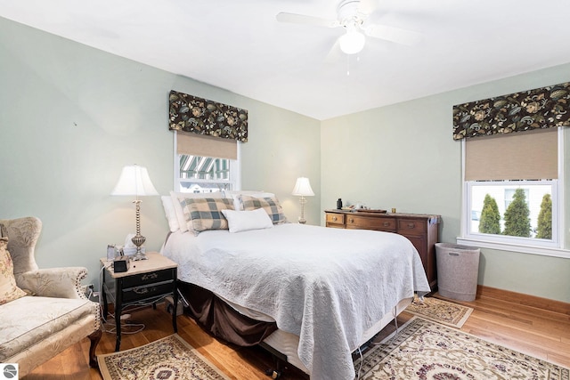 739 Stimson St, Cadillac, MI 49601 - bedroom with wood finished floors, multiple windows, and a ceiling fan