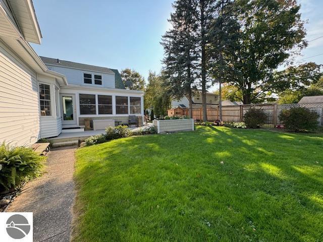 739 Stimson St, Cadillac, MI 49601 - view of yard featuring a sunroom