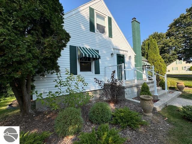 739 Stimson St, Cadillac, MI 49601 - view of front of house with a chimney