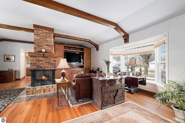 739 Stimson St, Cadillac, MI 49601 - living area featuring light wood-type flooring, a brick fireplace, and baseboards