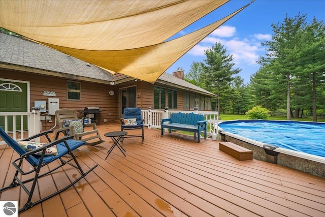 6369 Wooded Trl, Houghton Lake, MI 48629 - wooden terrace with an outdoor pool, an outdoor hangout area, and a grill