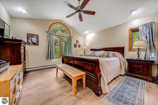 6369 Wooded Trl, Houghton Lake, MI 48629 - bedroom with vaulted ceiling, baseboard heating, light wood-type flooring, and ceiling fan