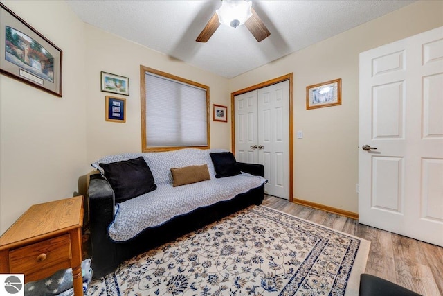 6369 Wooded Trl, Houghton Lake, MI 48629 - living room featuring ceiling fan and wood finished floors
