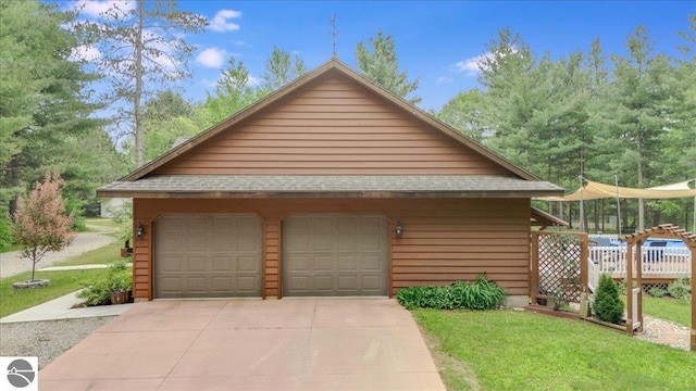 6369 Wooded Trl, Houghton Lake, MI 48629 - view of property exterior featuring a garage and an outdoor structure