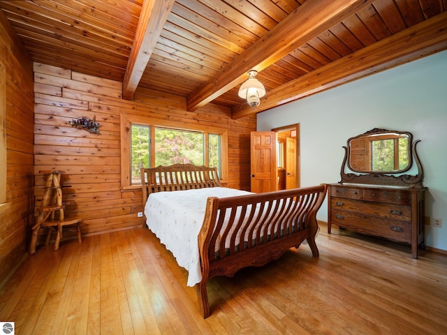 10037 Mud Lake Rd, Interlochen, MI 49643 - bedroom with a wooden ceiling with exposed beams, light wood-style floors, and wooden walls