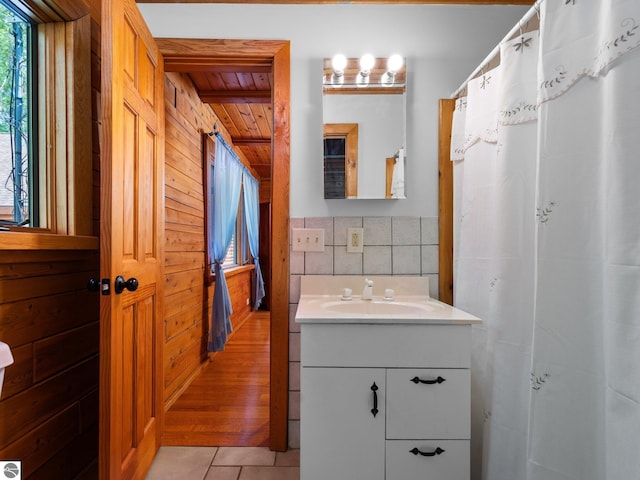 10037 Mud Lake Rd, Interlochen, MI 49643 - bathroom featuring vanity, tile patterned flooring, wood ceiling, and wooden walls