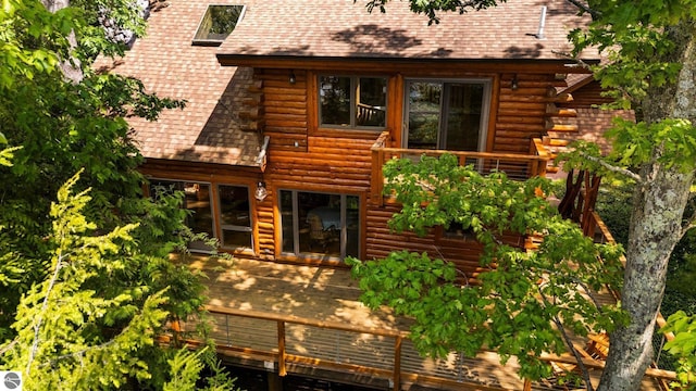 10037 Mud Lake Rd, Interlochen, MI 49643 - rear view of property featuring a deck, log siding, and a shingled roof