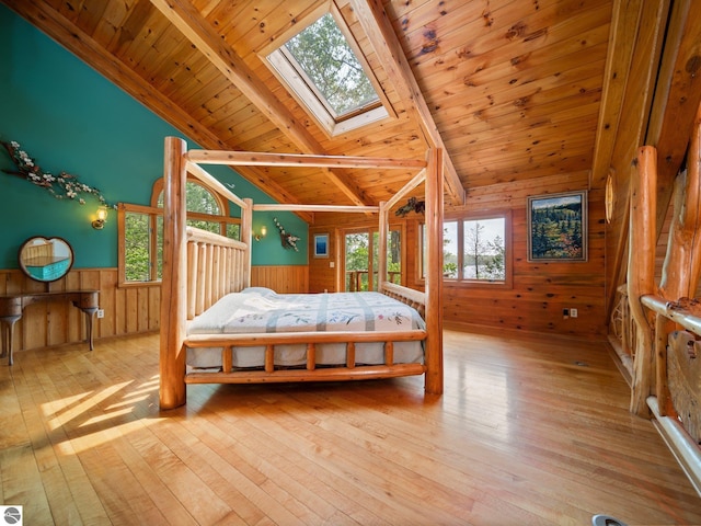 10037 Mud Lake Rd, Interlochen, MI 49643 - bedroom with wooden walls, wood-type flooring, multiple windows, wooden ceiling, and wainscoting