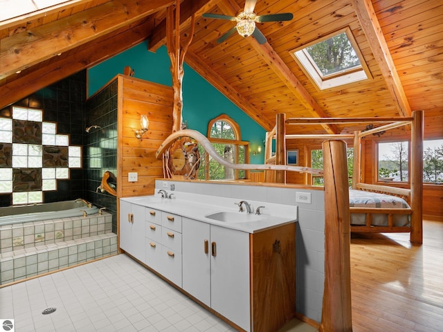 10037 Mud Lake Rd, Interlochen, MI 49643 - ensuite bathroom with a skylight, wood ceiling, double vanity, ceiling fan, and tile patterned floors