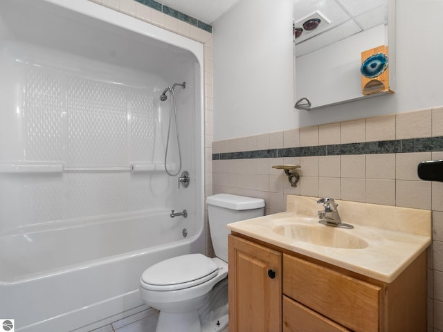 10037 Mud Lake Rd, Interlochen, MI 49643 - bathroom featuring tile walls, vanity, shower / tub combination, a wainscoted wall, and tile patterned flooring