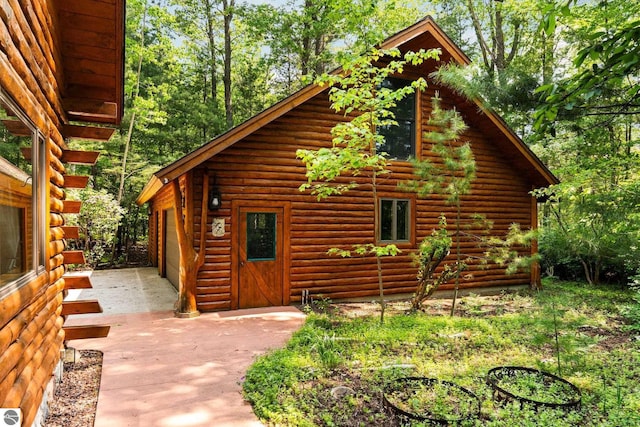 10037 Mud Lake Rd, Interlochen, MI 49643 - view of side of home with an outbuilding
