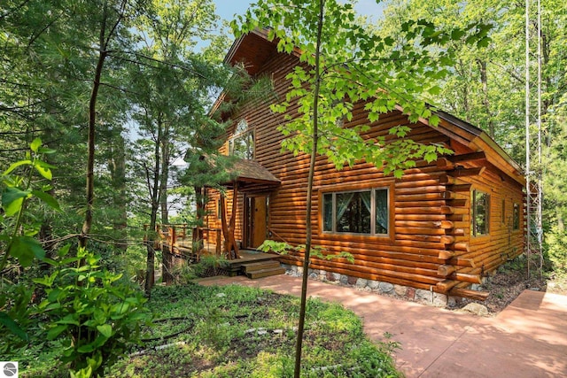 10037 Mud Lake Rd, Interlochen, MI 49643 - cabin with log siding