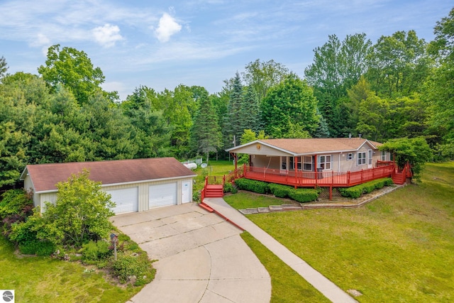 19275 Coates Hwy, Brethren, MI 49619 - single story home featuring a garage, a front yard, a wooded view, an outdoor structure, and covered porch