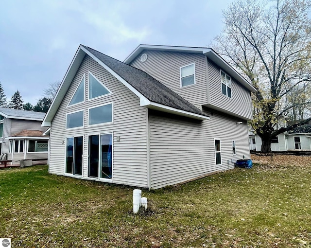 1415 Paczesny Pl, Central Lake, MI 49622 - back of house with a yard and roof with shingles