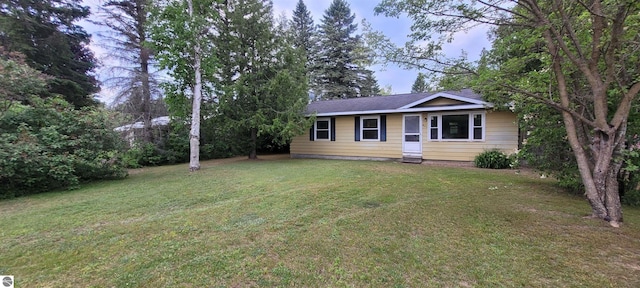 601 Monroe, Mancelona, MI 49659 - single story home featuring a front lawn