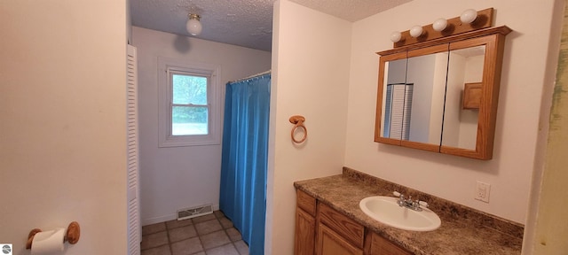 601 Monroe, Mancelona, MI 49659 - bathroom with vanity, a textured ceiling, tile patterned flooring, and curtained shower