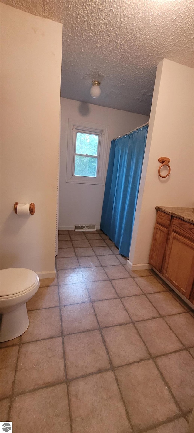 601 Monroe, Mancelona, MI 49659 - bathroom with a textured ceiling, tile patterned flooring, and vanity
