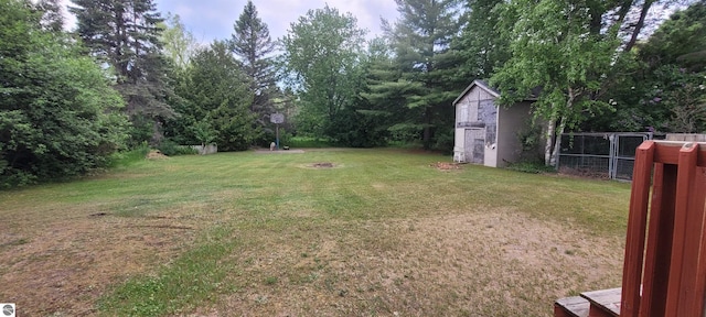 601 Monroe, Mancelona, MI 49659 - view of yard featuring an outdoor fire pit and a shed