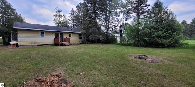 601 Monroe, Mancelona, MI 49659 - view of green lawn with an outdoor fire pit