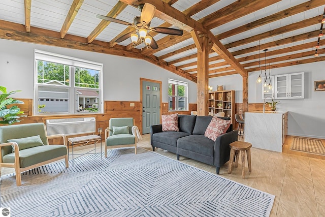 3872 Falling Leaf Trl, Traverse City, MI 49686 - living area featuring a wainscoted wall, wooden walls, a ceiling fan, and a wall unit AC