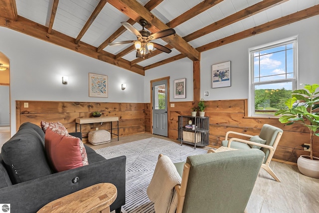 3872 Falling Leaf Trl, Traverse City, MI 49686 - living room featuring a wainscoted wall, wood walls, a ceiling fan, and wooden ceiling