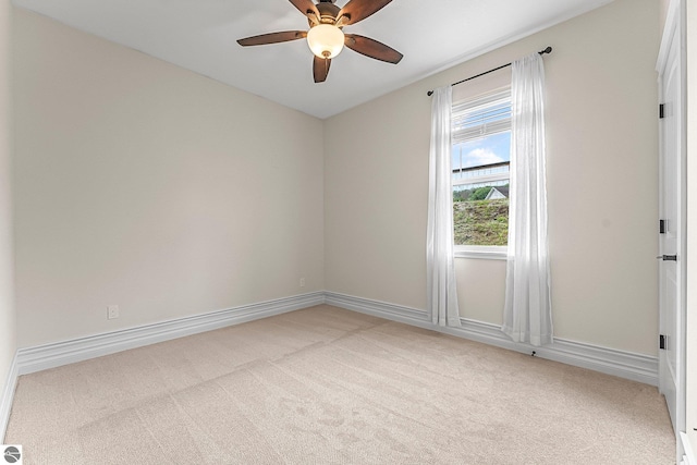 3872 Falling Leaf Trl, Traverse City, MI 49686 - spare room with light colored carpet and ceiling fan