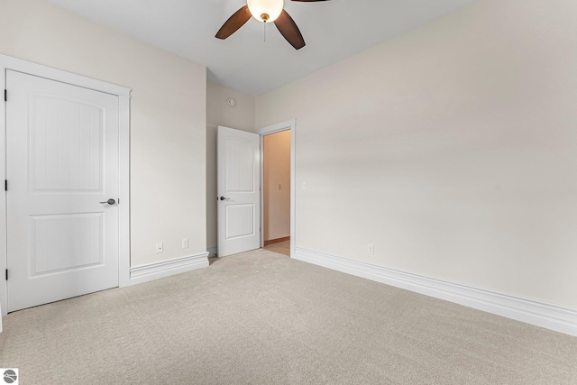 3872 Falling Leaf Trl, Traverse City, MI 49686 - unfurnished bedroom featuring light colored carpet and ceiling fan