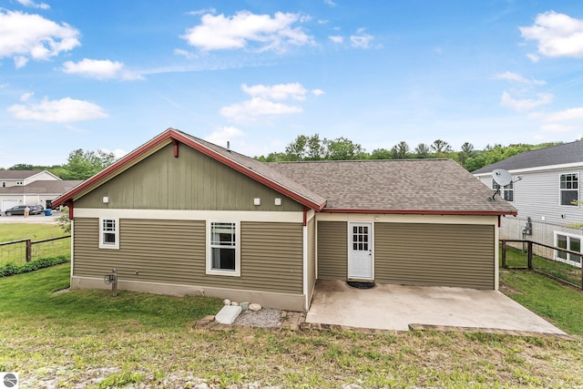 3872 Falling Leaf Trl, Traverse City, MI 49686 - back of property with a patio and roof with shingles