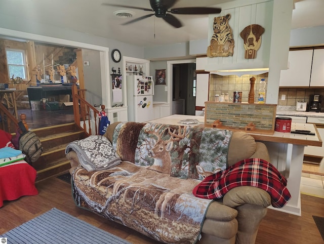 5094 SW Old Butler Rd Unit 1, South Boardman, MI 49680 - living room with ceiling fan, wood finished floors, and stairs