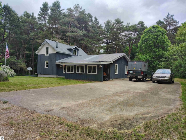 5094 SW Old Butler Rd Unit 1, South Boardman, MI 49680 - view of front of home with a metal roof, driveway, and a front yard