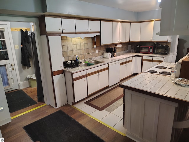 5094 SW Old Butler Rd Unit 1, South Boardman, MI 49680 - kitchen featuring dishwasher, white cabinetry, tasteful backsplash, and tile counters