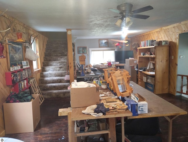 5094 SW Old Butler Rd Unit 1, South Boardman, MI 49680 - dining space with plenty of natural light, wood finished floors, stairway, a ceiling fan, and wooden walls
