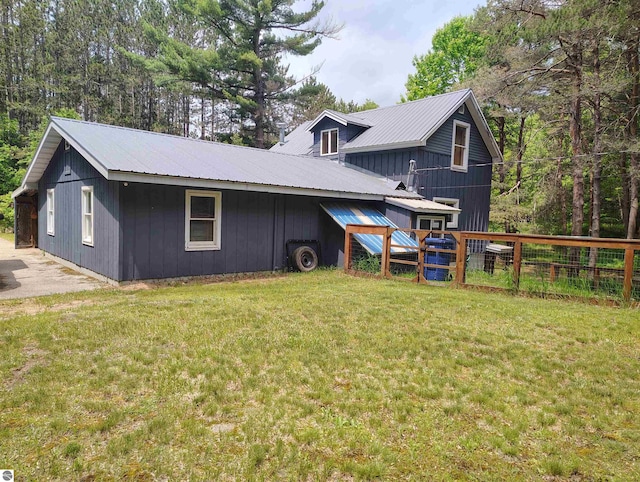 5094 SW Old Butler Rd Unit 1, South Boardman, MI 49680 - rear view of property with a metal roof