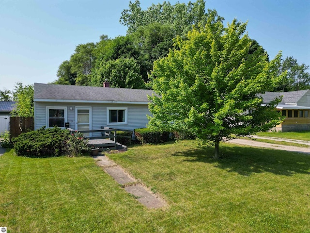1220 E Gaylord St, Mount Pleasant, MI 48858 - view of front facade featuring a front yard and a wooden deck