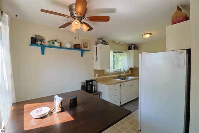 1220 E Gaylord St, Mount Pleasant, MI 48858 - kitchen with freestanding refrigerator, ceiling fan, white cabinetry, and light countertops