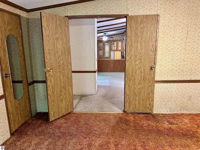 8334 Cinder Hill Rd, Mancelona, MI 49659 - carpeted empty room with wallpapered walls, vaulted ceiling, and ornamental molding
