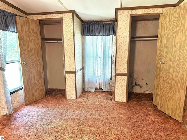 8334 Cinder Hill Rd, Mancelona, MI 49659 - unfurnished bedroom with wallpapered walls, ornamental molding, and carpet flooring