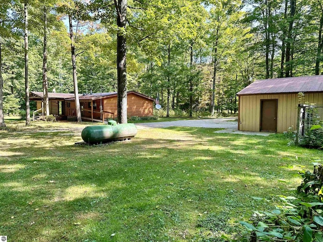 8334 Cinder Hill Rd, Mancelona, MI 49659 - view of grassy yard with a shed and a wooded view