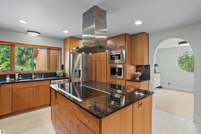 4340 E Huron River Dr, Ann Arbor, MI 48105 - kitchen featuring island range hood, appliances with stainless steel finishes, arched walkways, plenty of natural light, and recessed lighting