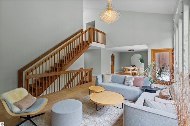 4340 E Huron River Dr, Ann Arbor, MI 48105 - living room with a high ceiling, wood finished floors, arched walkways, and stairway
